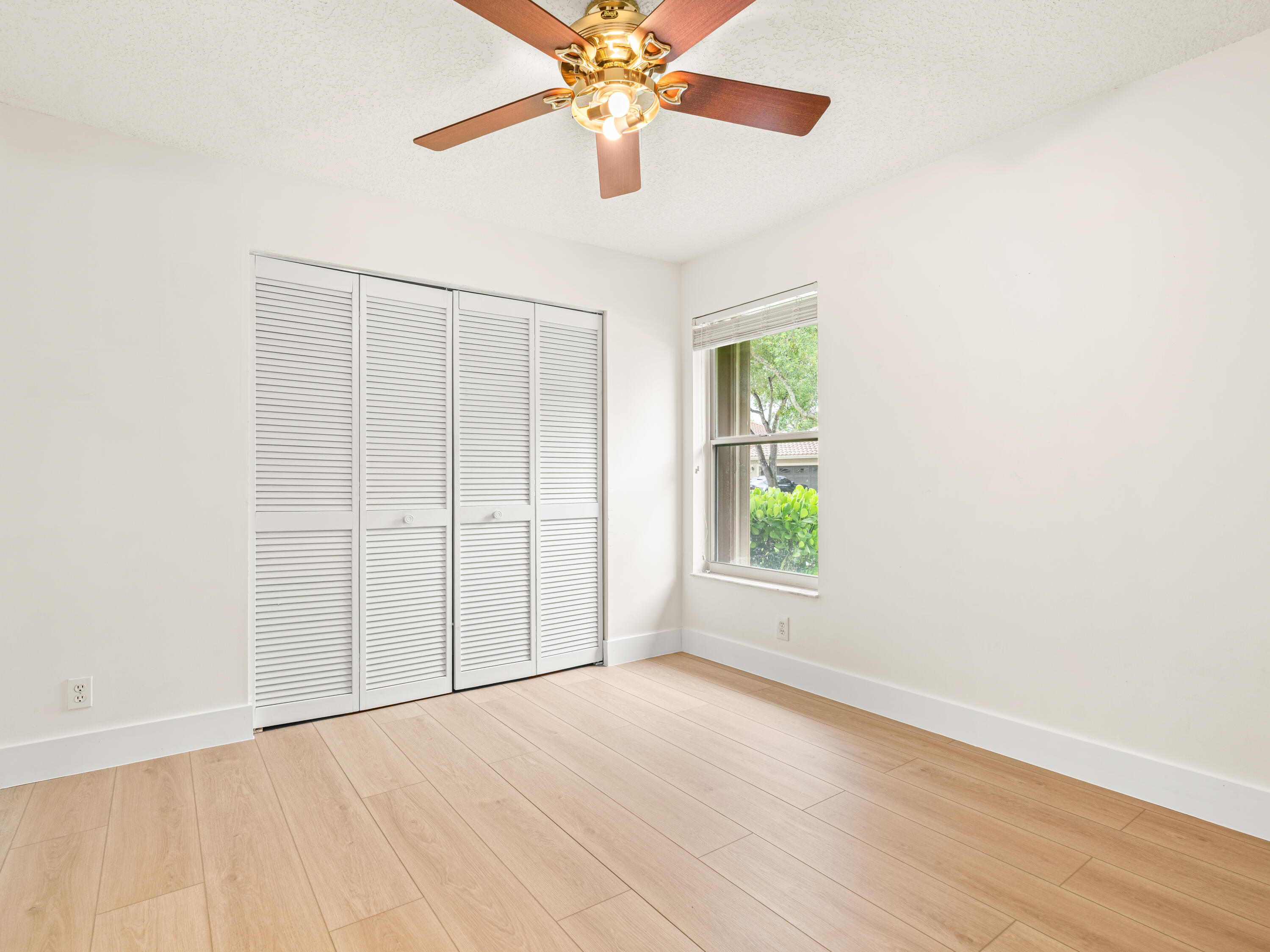 833 Heron Road Weston, FL 33326 - Photo 18 of 34 an empty room with chandelier fan and windows