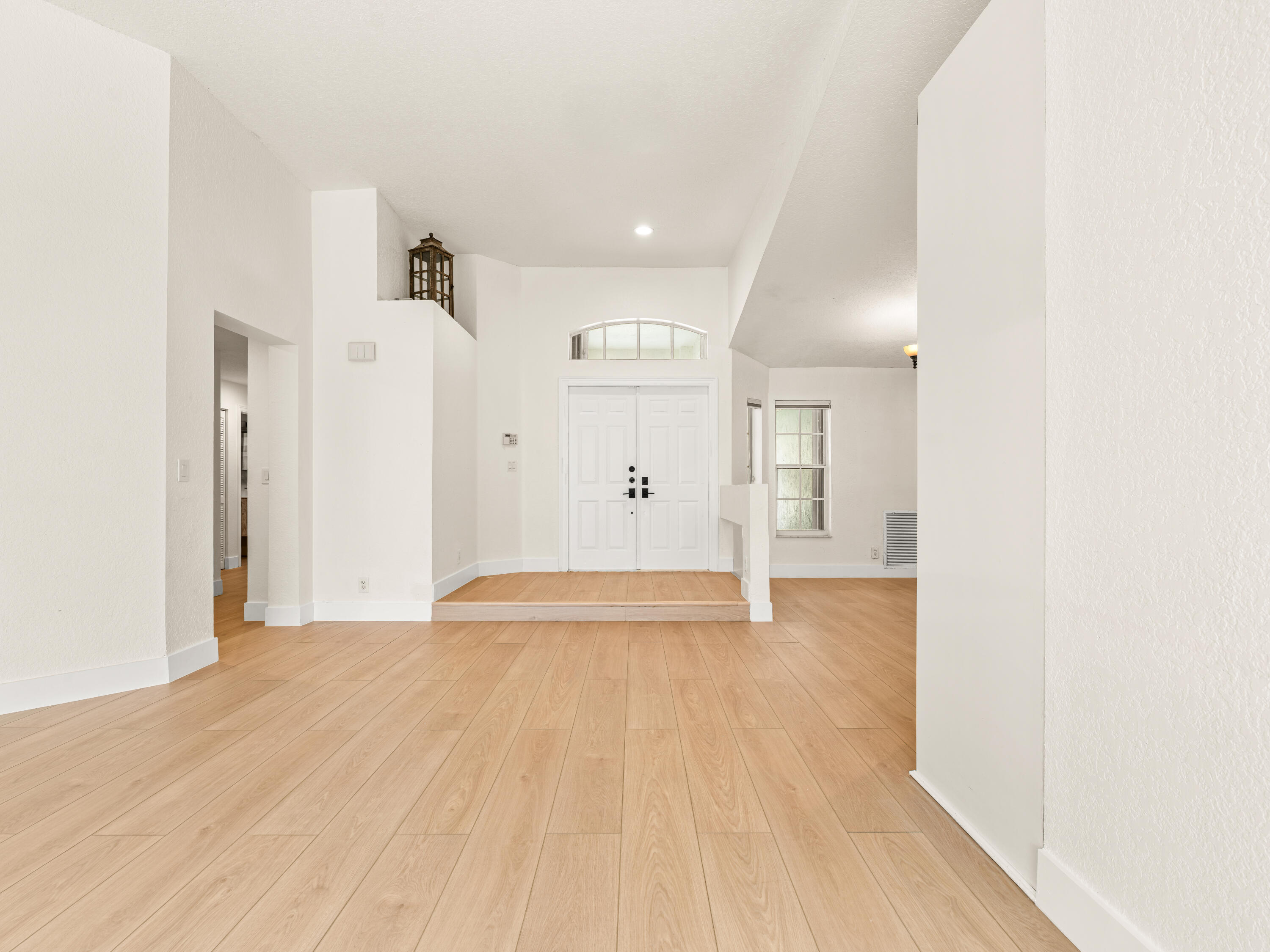 833 Heron Road Weston, FL 33326 - Photo 4 of 34 a view of an empty room with wooden floor