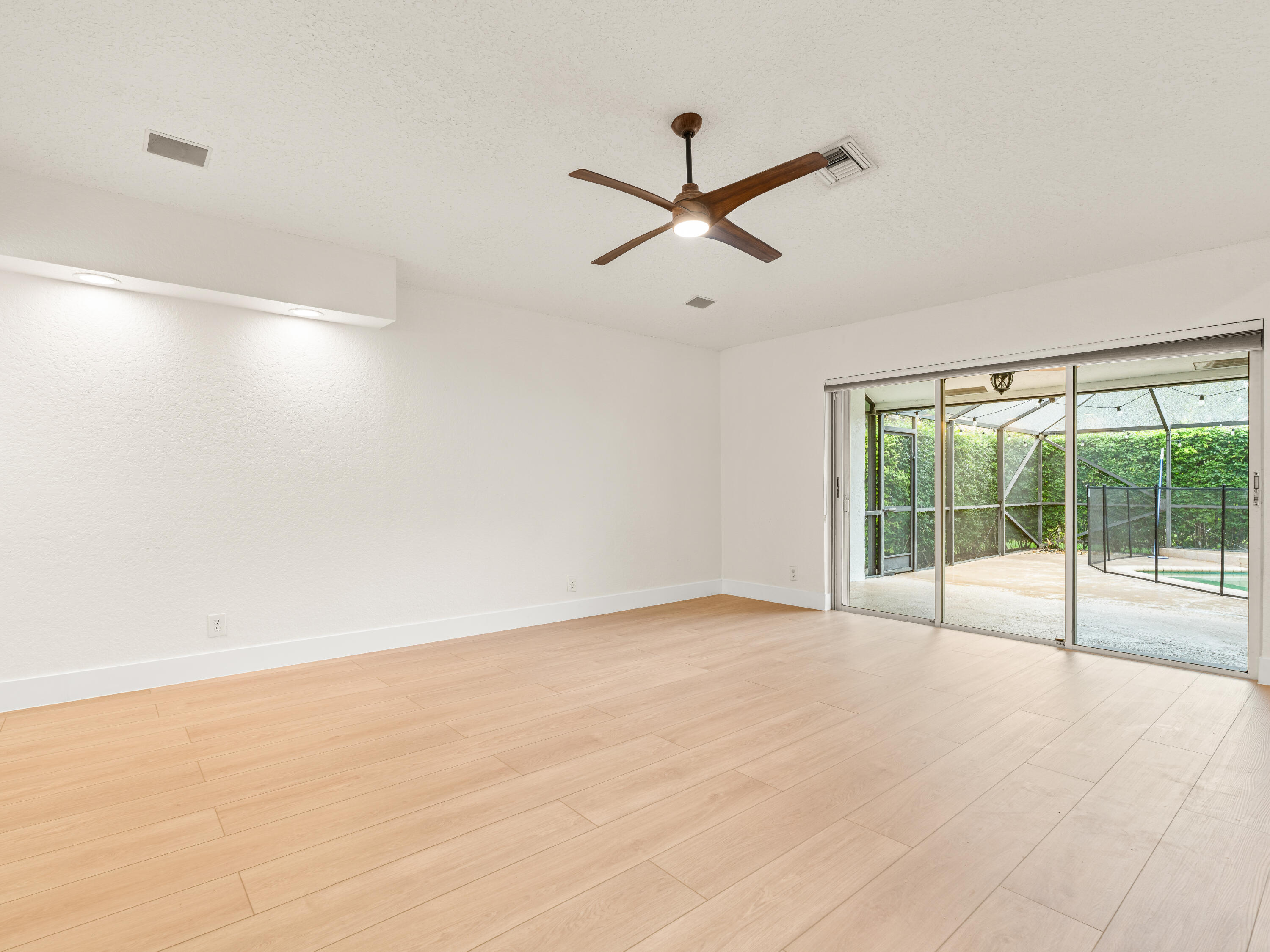 833 Heron Road Weston, FL 33326 - Photo 7 of 34 wooden floor in an empty room with a window