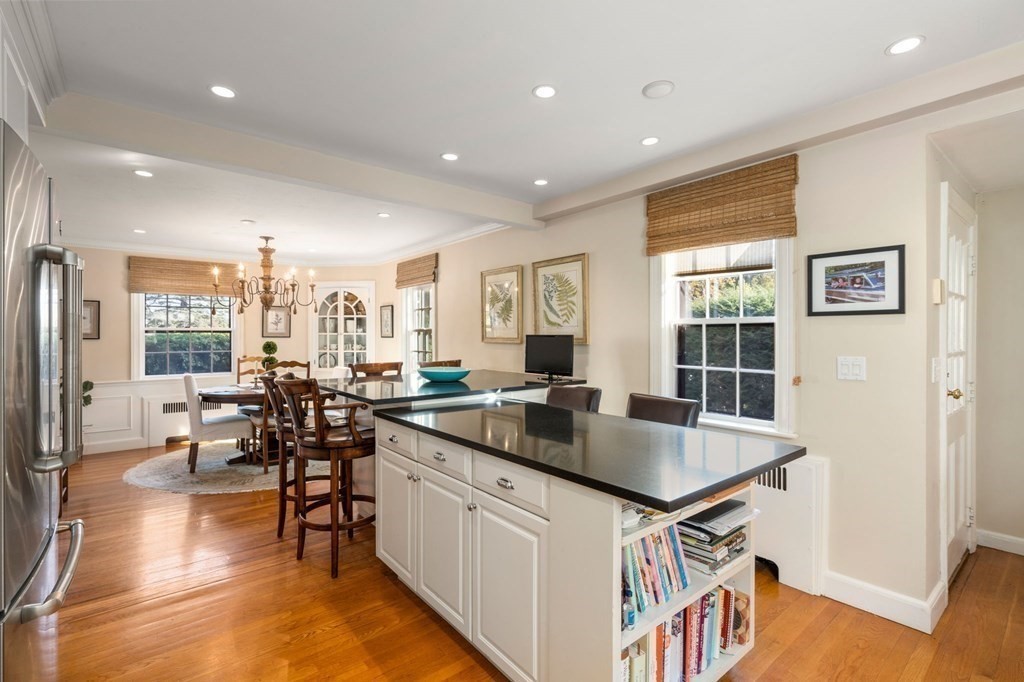 14 Hillcroft Road Boston, MA 02130 - Photo 12 of 34 a kitchen with stainless steel appliances granite countertop a table chairs and a refrigerator