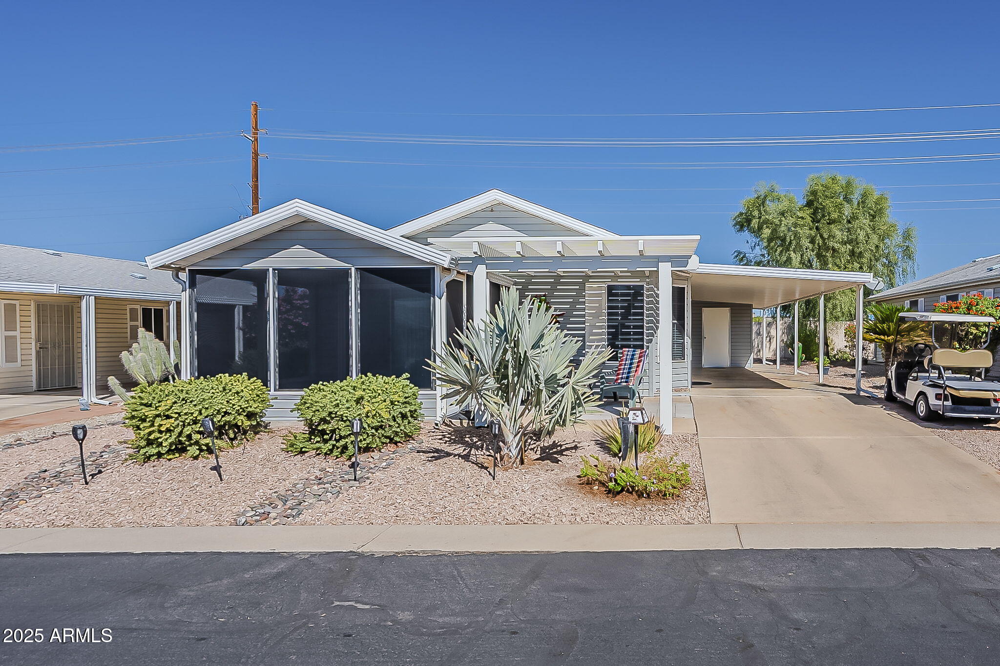 215 North Power Road, Unit 107 Mesa, AZ 85205 - Photo 13 of 49 a front view of a house with a yard