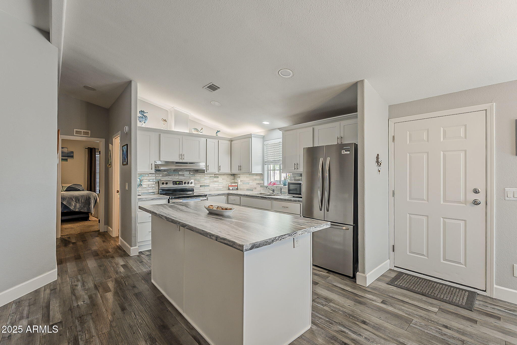 215 North Power Road, Unit 107 Mesa, AZ 85205 - Photo 16 of 49 a kitchen with kitchen island a sink stove and refrigerator