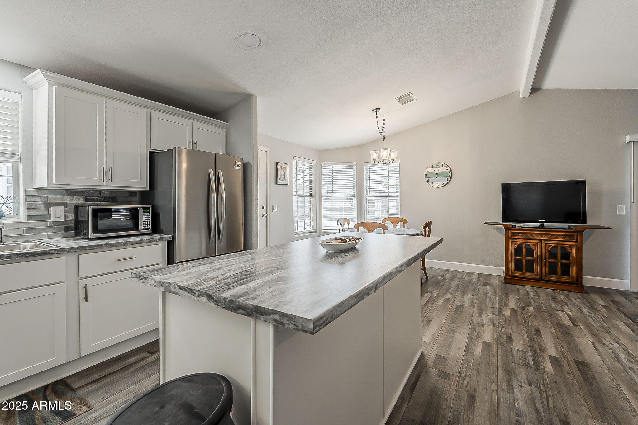 215 North Power Road, Unit 107 Mesa, AZ 85205 - Photo 17 of 49 a kitchen with stainless steel appliances a sink stove and refrigerator