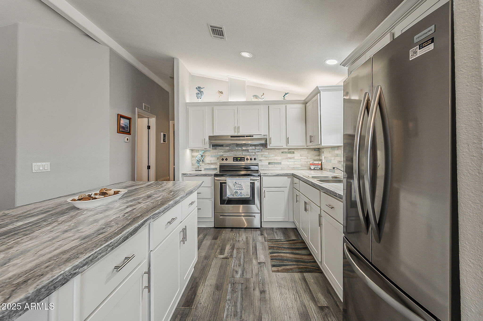 215 North Power Road, Unit 107 Mesa, AZ 85205 - Photo 18 of 49 a kitchen with stainless steel appliances granite countertop a refrigerator and a stove top oven