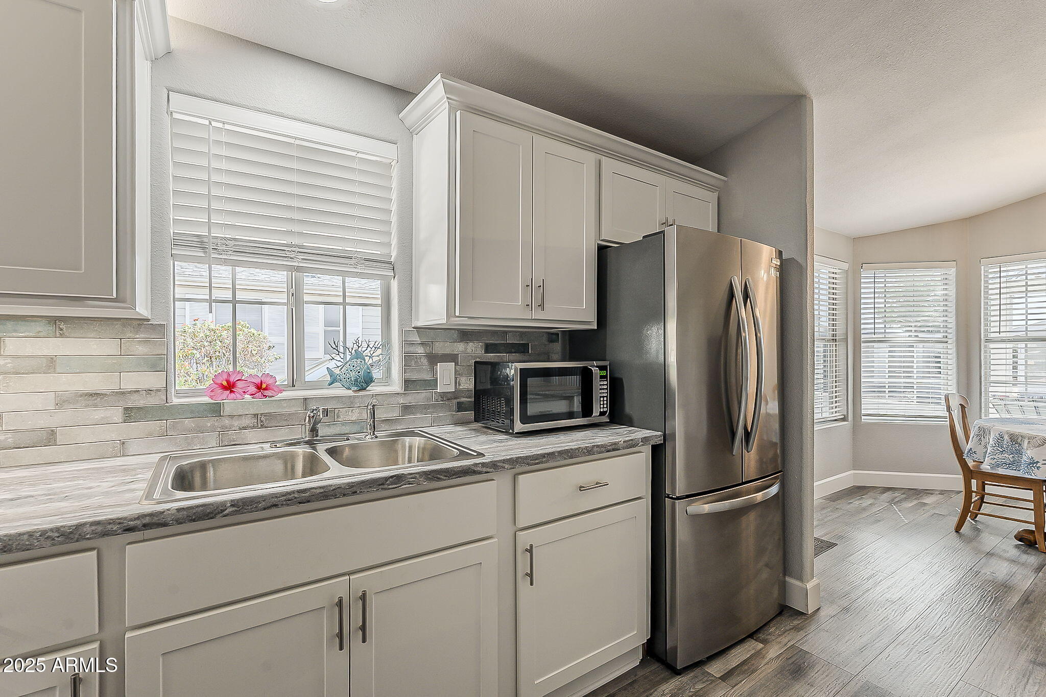 215 North Power Road, Unit 107 Mesa, AZ 85205 - Photo 20 of 49 a kitchen with appliances a sink cabinets and a window