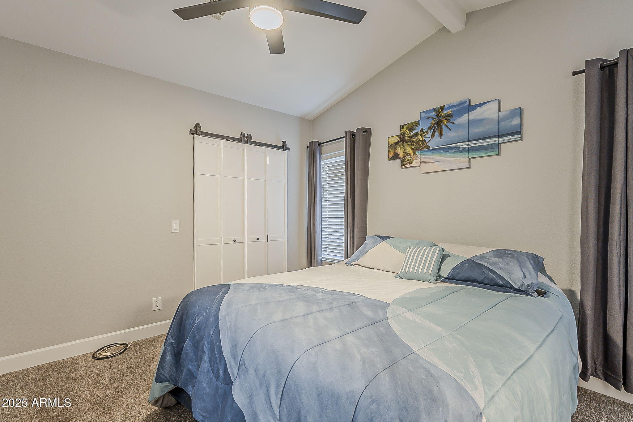215 North Power Road, Unit 107 Mesa, AZ 85205 - Photo 25 of 49 a bedroom with a bed and a chandelier