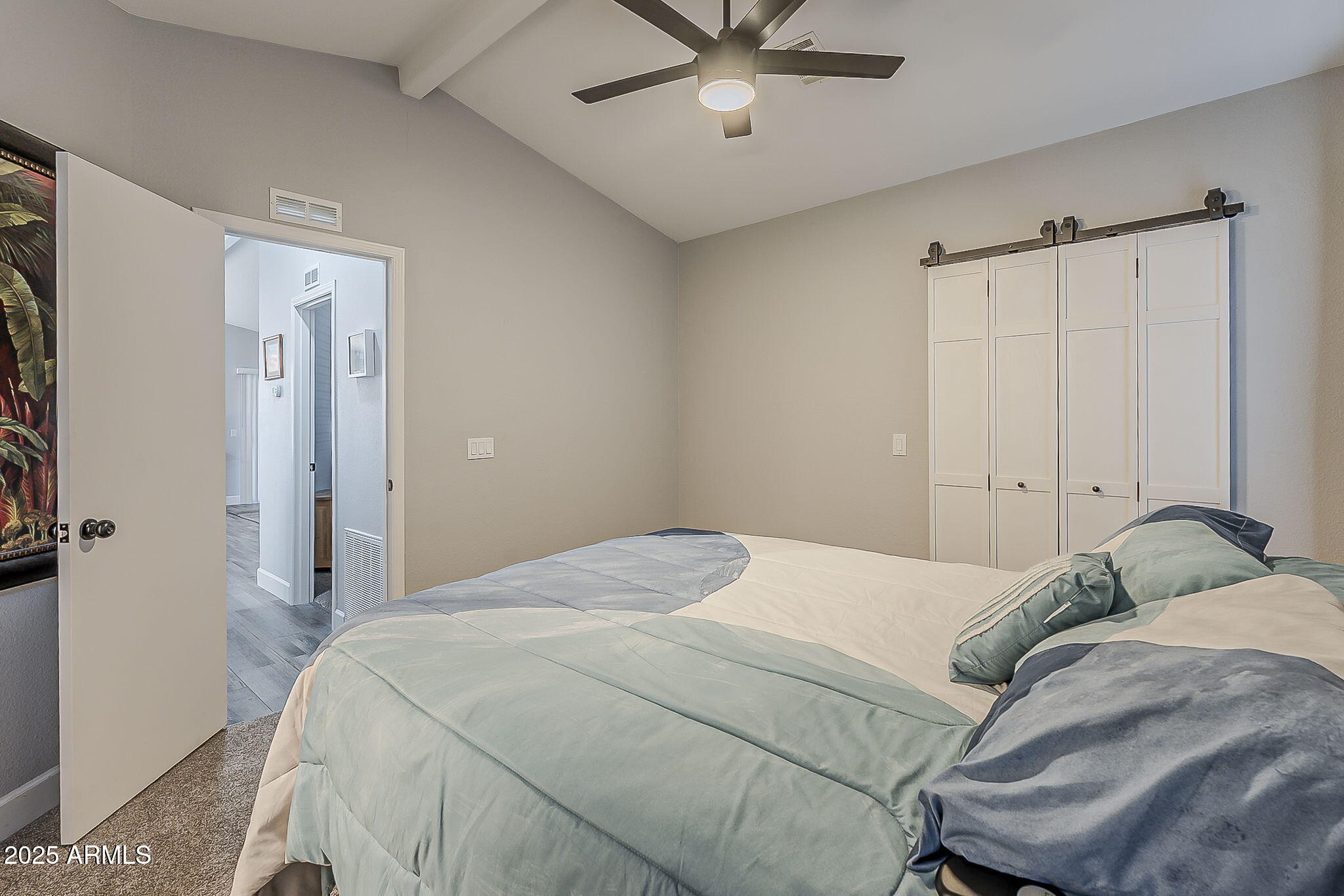 215 North Power Road, Unit 107 Mesa, AZ 85205 - Photo 26 of 49 a bedroom with a bed and a chandelier