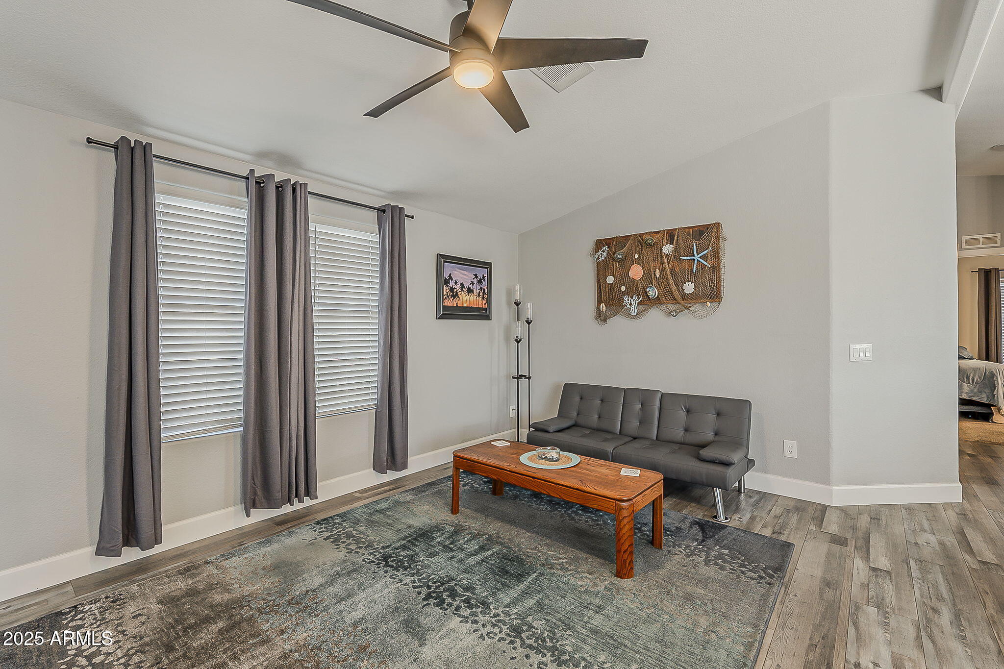 215 North Power Road, Unit 107 Mesa, AZ 85205 - Photo 27 of 49 a living room with furniture rug and wooden floor