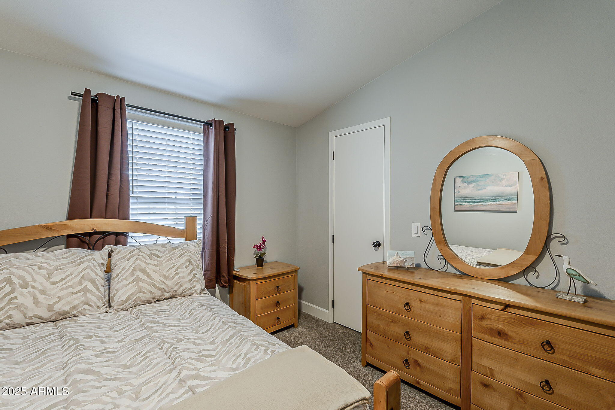 215 North Power Road, Unit 107 Mesa, AZ 85205 - Photo 30 of 49 a bedroom with a bed and a dresser
