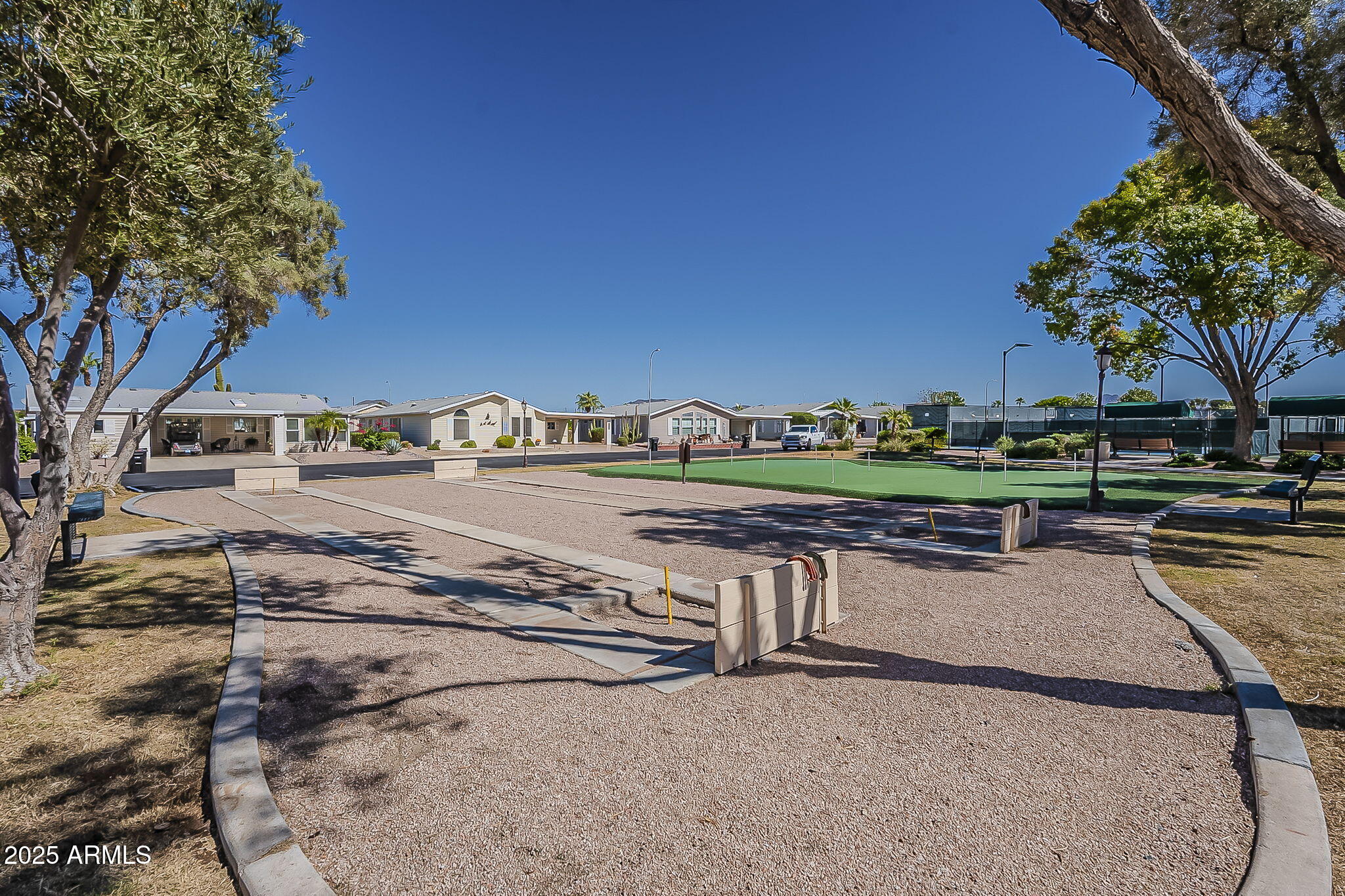 215 North Power Road, Unit 107 Mesa, AZ 85205 - Photo 32 of 49 a view of a street with a yard and large trees