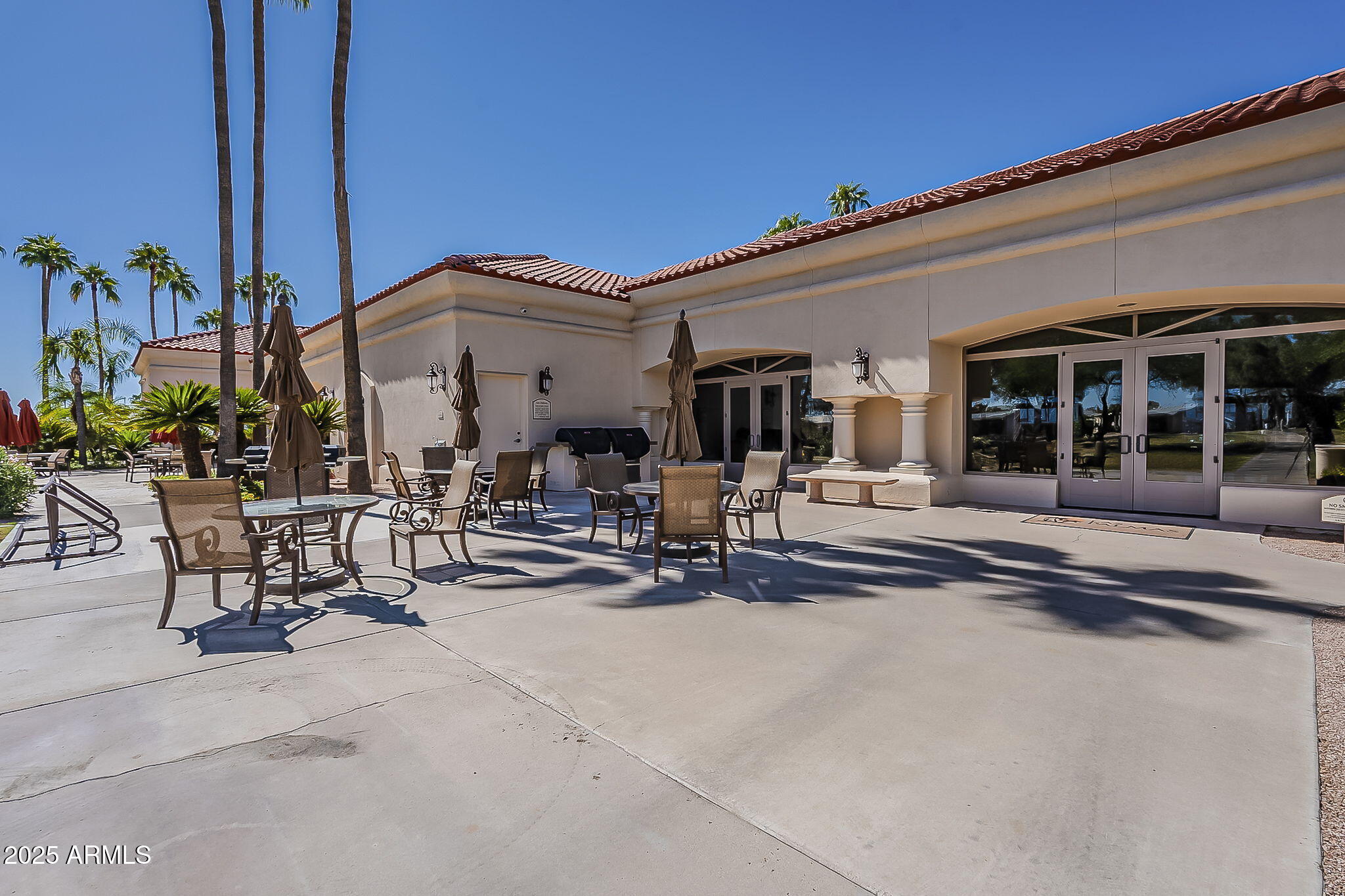 215 North Power Road, Unit 107 Mesa, AZ 85205 - Photo 41 of 49 a view of a patio with table and chairs and potted plants