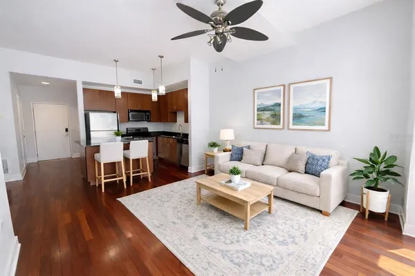 a living room with furniture a wooden floor and chandelier