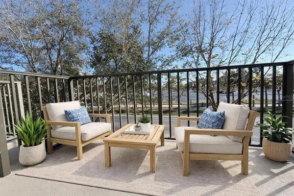 a balcony with furniture and potted plants