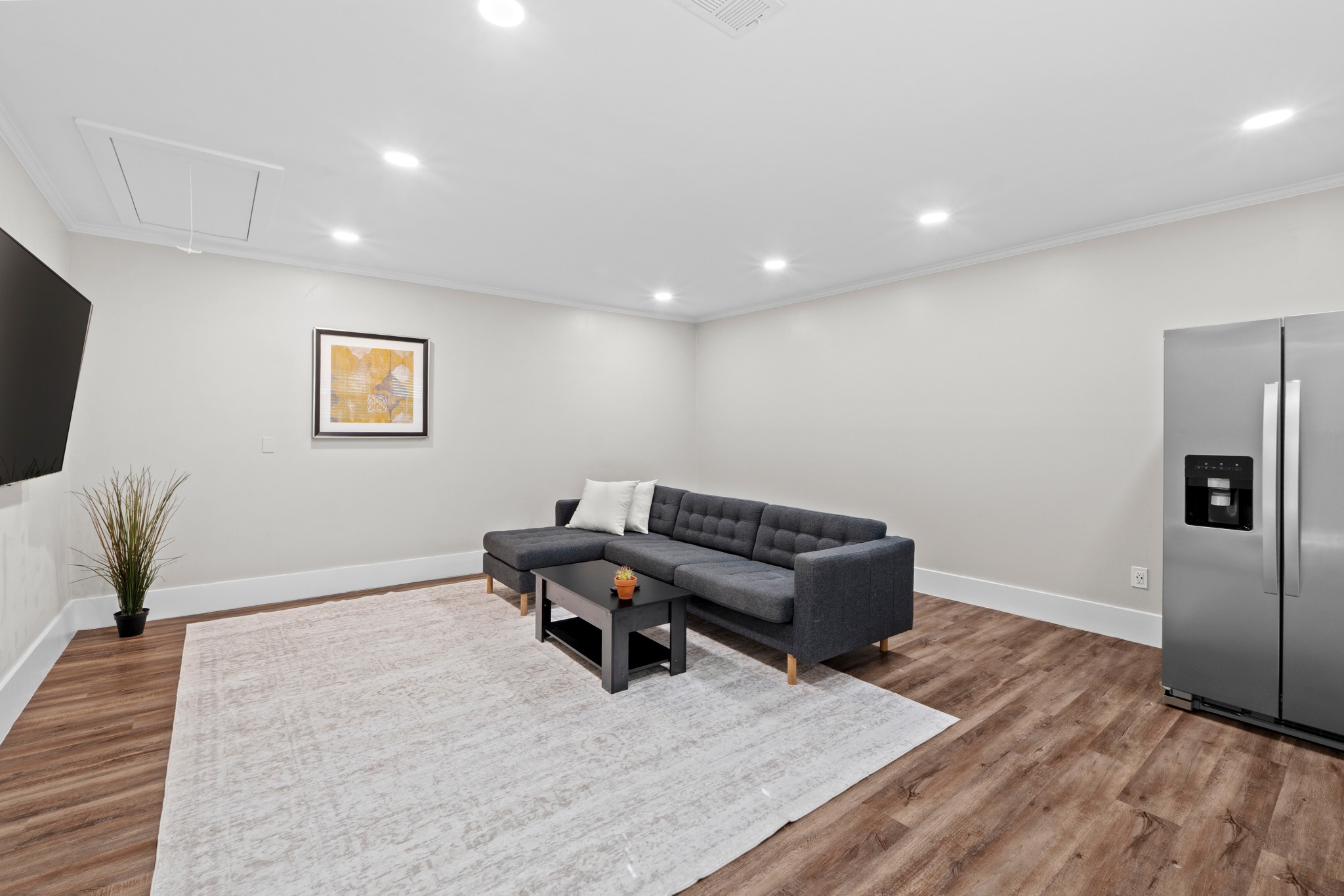 11811 Rotherham Drive Austin, TX 78754 - Photo 14 of 37 Recessed lighting illuminates this versatile living space with rich hardwood-style flooring.