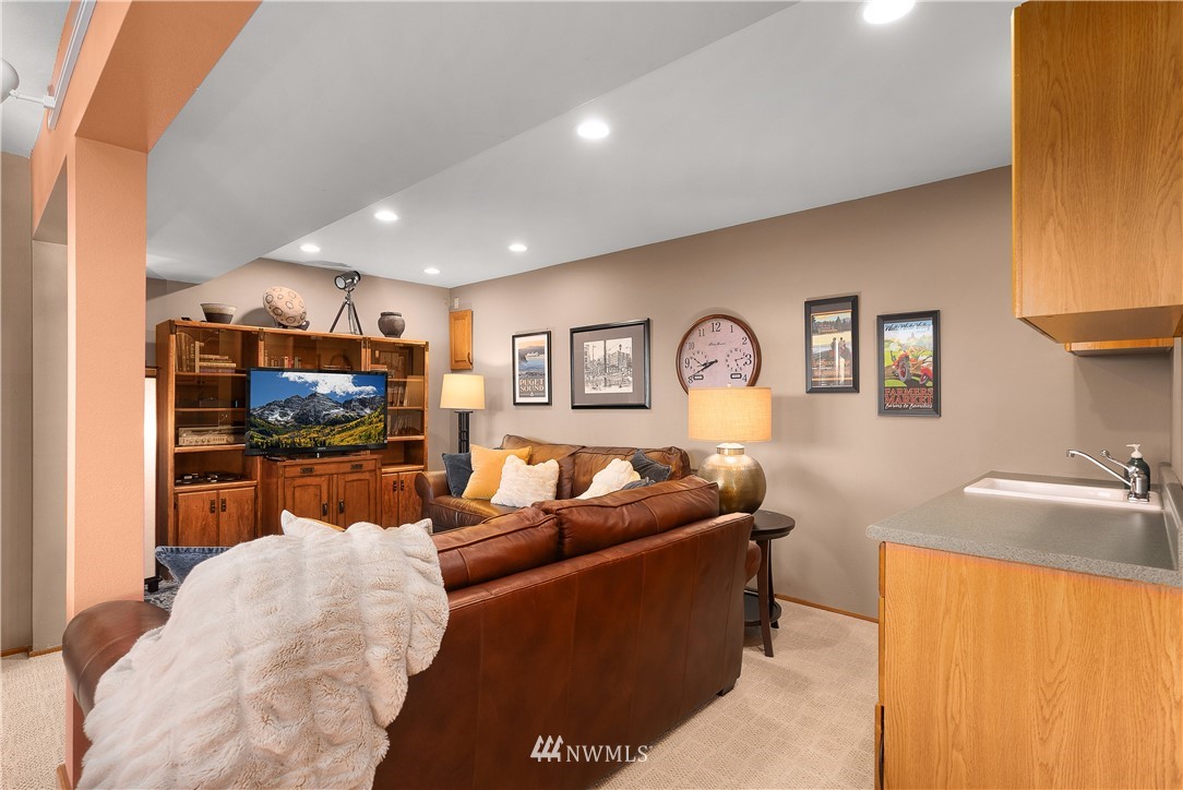 4910 23rd Avenue West Everett, WA 98203 - Photo 22 of 40 a living room with fireplace furniture and a flat screen tv