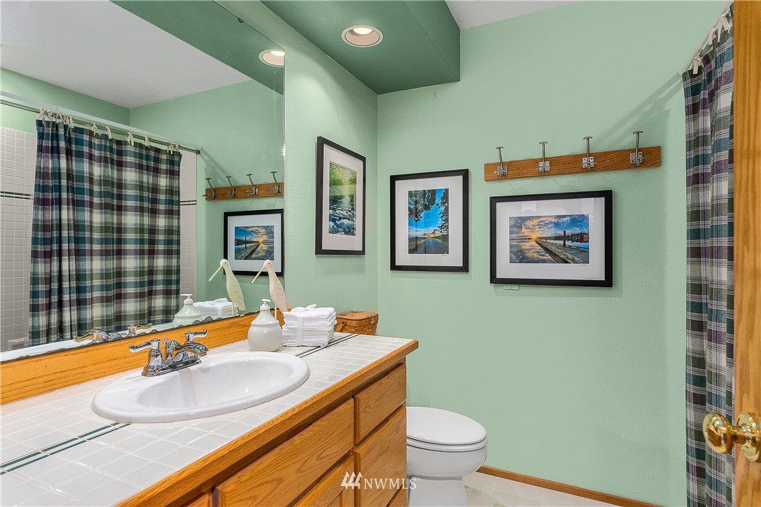 4910 23rd Avenue West Everett, WA 98203 - Photo 25 of 40 a bathroom with a granite countertop sink and a mirror