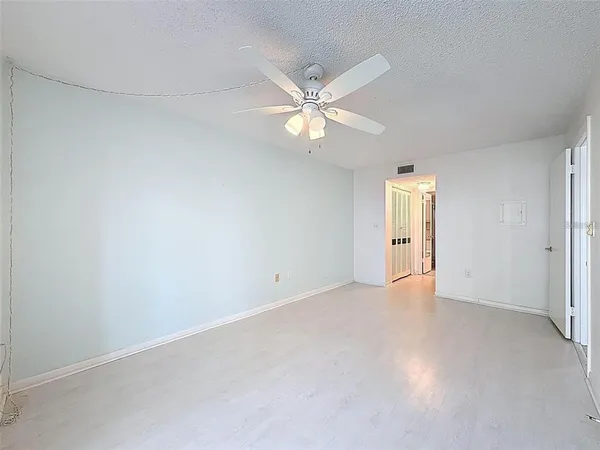 an empty room with closet and windows