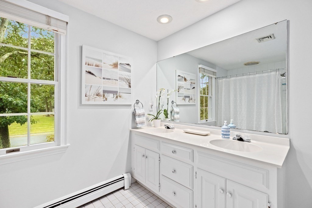 6 Pheasant Run Hingham, MA 02043 - Photo 30 of 41 a bathroom with a double vanity sink a mirror and next to a window