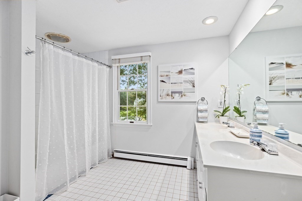 6 Pheasant Run Hingham, MA 02043 - Photo 31 of 41 a bathroom with a sink a mirror and a shower curtain