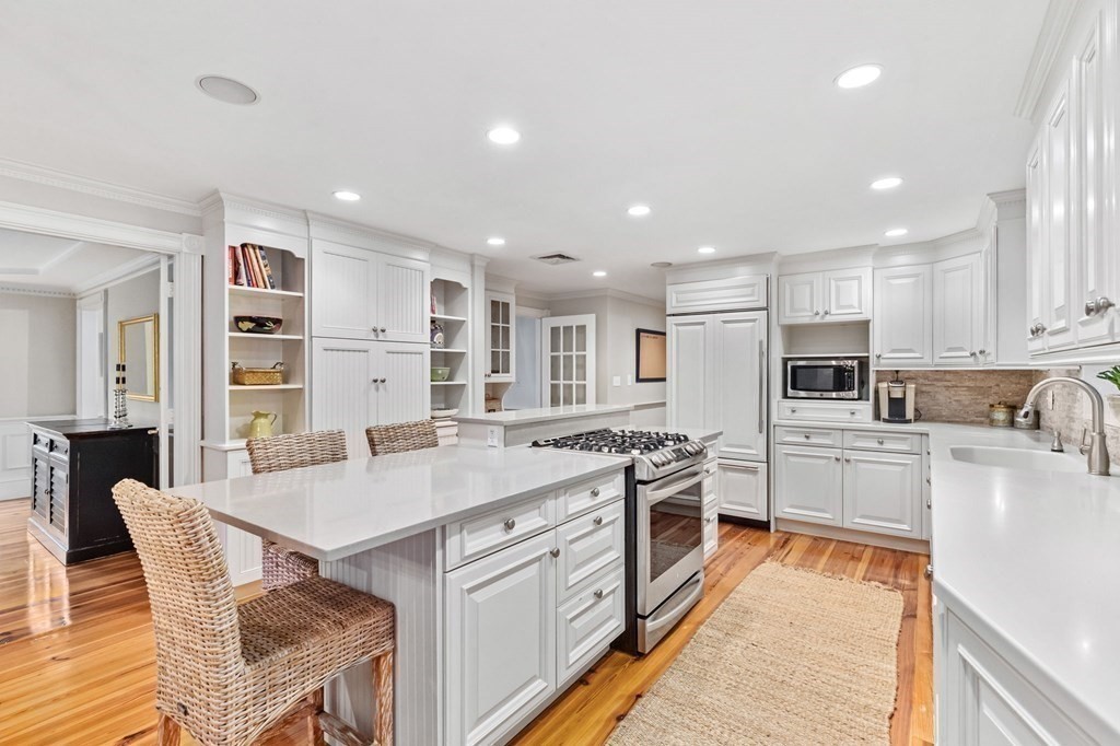 6 Pheasant Run Hingham, MA 02043 - Photo 8 of 41 a large kitchen with stainless steel appliances kitchen island granite countertop a stove a sink a refrigerator and white cabinets