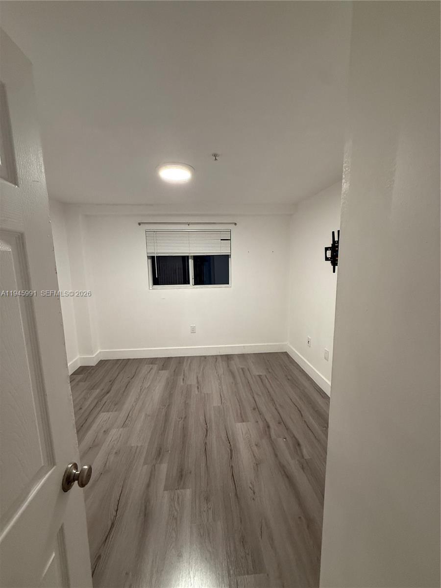 an empty room with wooden floor