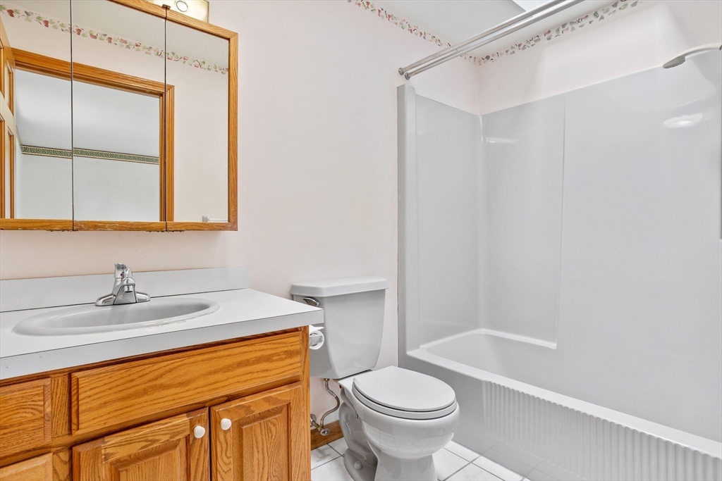 13 Lexington Road Billerica, MA 01821 - Photo 18 of 25 a bathroom with a sink toilet and shower