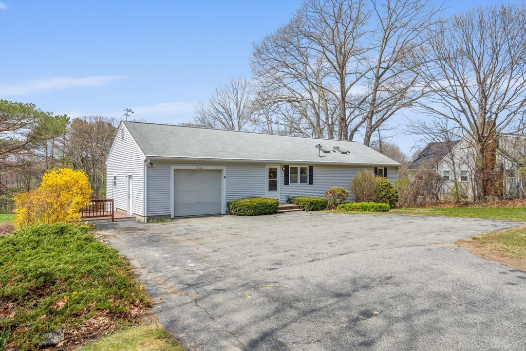 13 Lexington Road Billerica, MA 01821 - Photo 2 of 25 a front view of a house with a yard and garage
