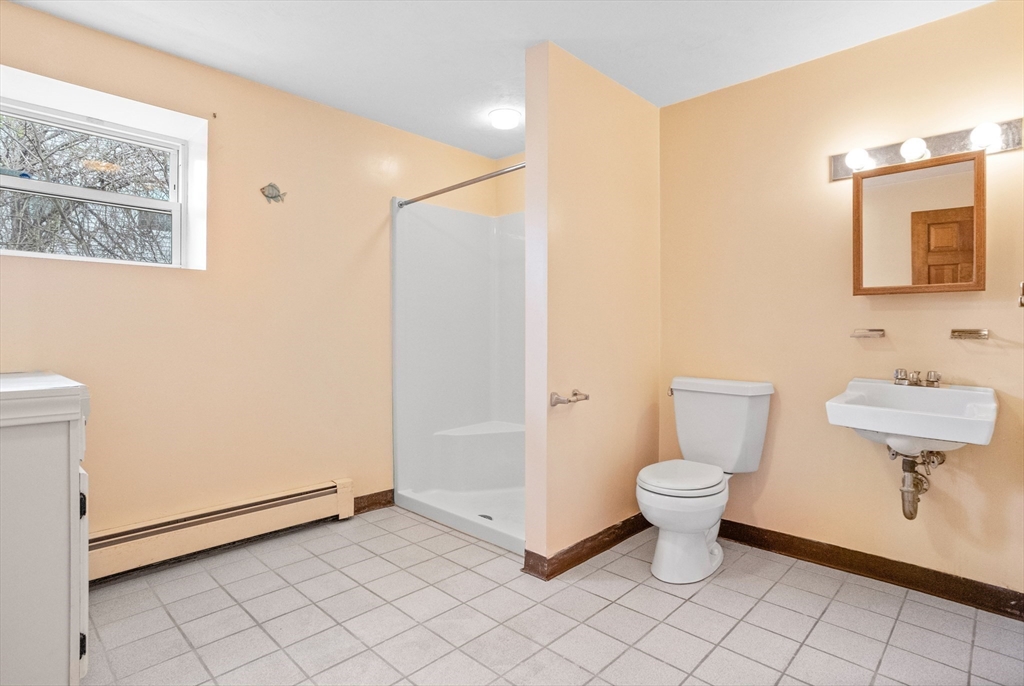 13 Lexington Road Billerica, MA 01821 - Photo 21 of 25 a bathroom with a toilet sink and a mirror