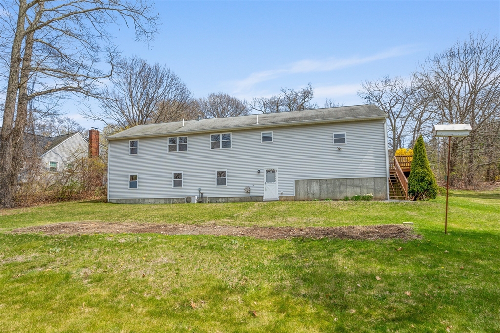 13 Lexington Road Billerica, MA 01821 - Photo 4 of 25 a view of a backyard with plants and large tree