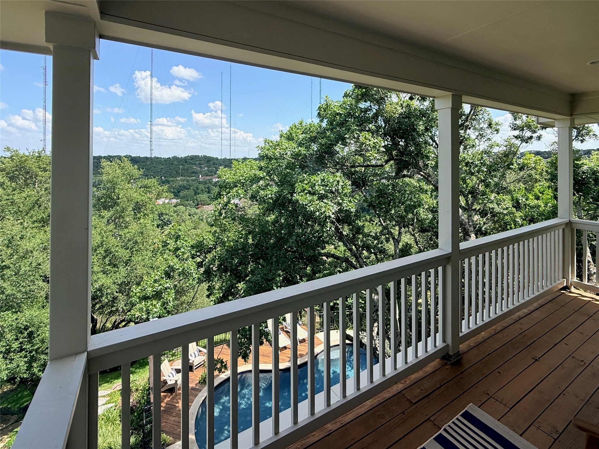 3107 Lookout Lane Austin, TX 78746 - Photo 29 of 39 A spacious covered balcony overlooks a private pool and verdant tree-filled hills.