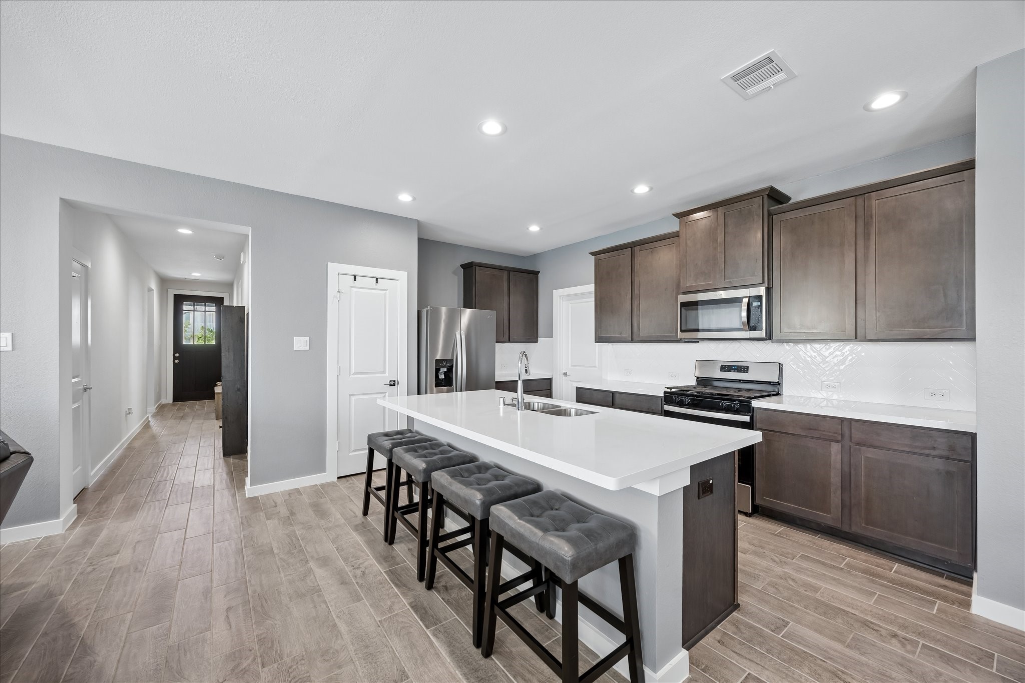 33002 Carolyns Perfection Loop Fulshear, TX 77441 - Photo 4 of 29 Kitchen with island and stainless steel appliances.