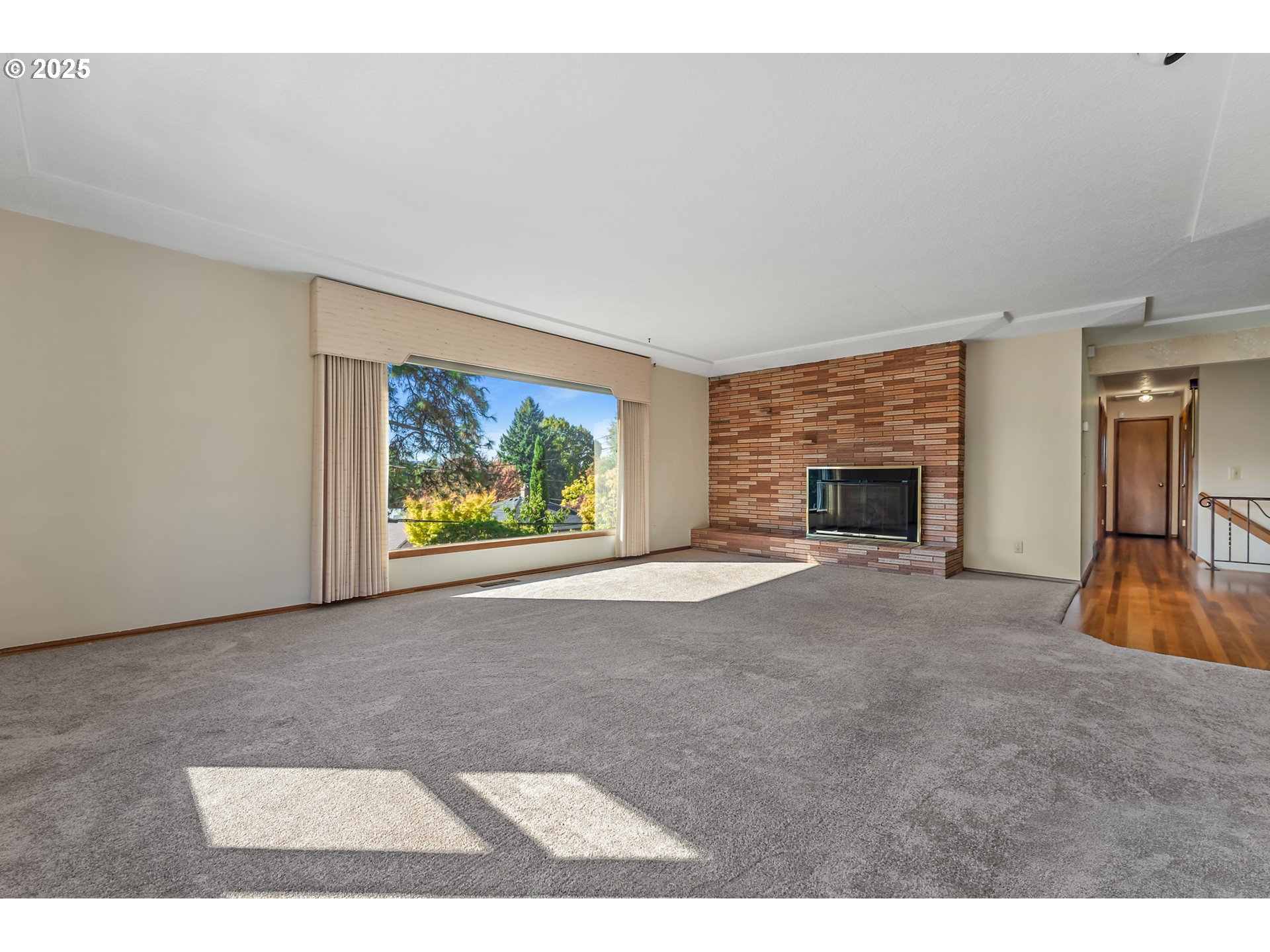 4430 Southeast Flavel Street Portland, OR 97206 - Photo 14 of 43 a view of an empty room with a fireplace and a window