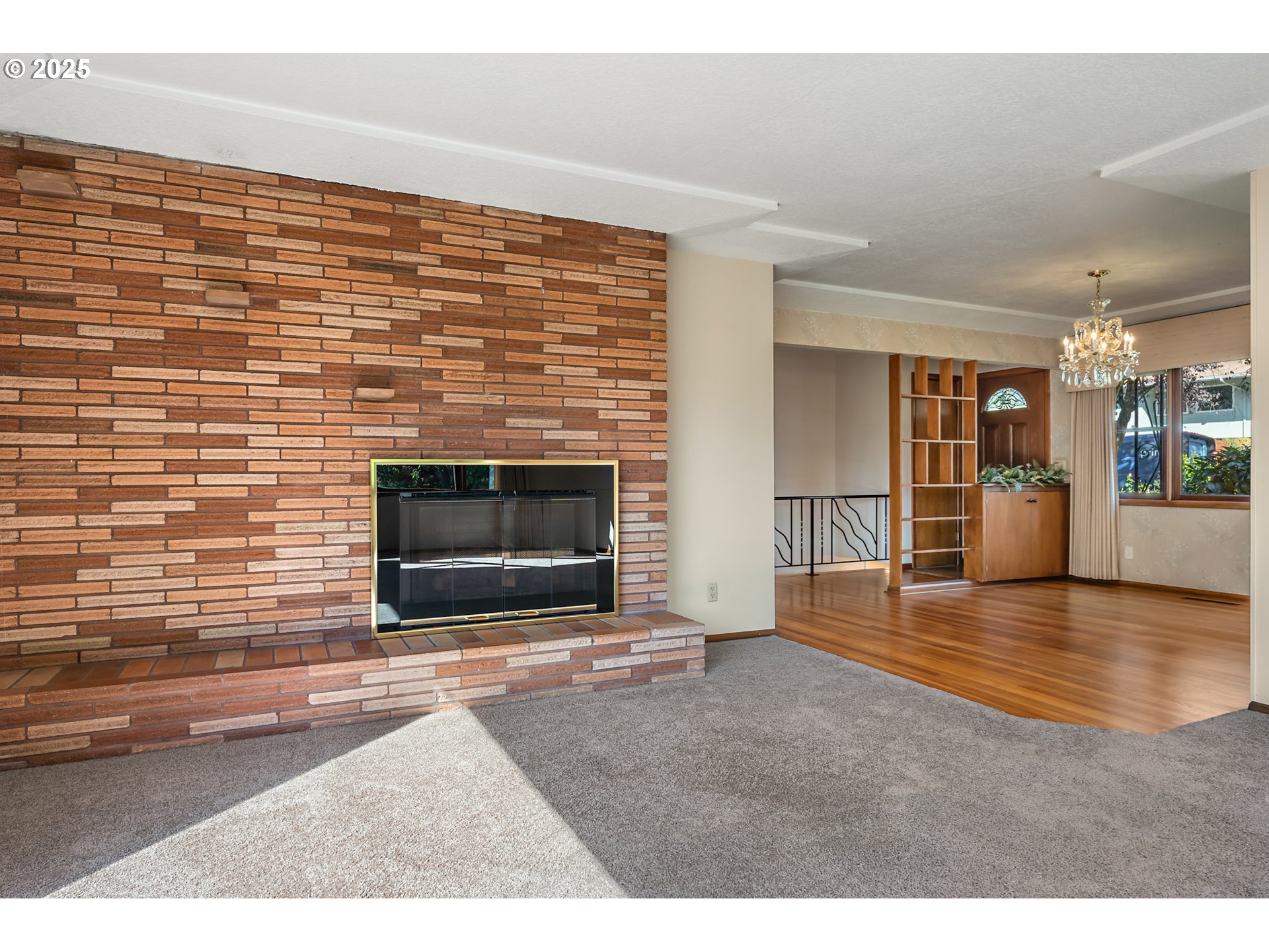 4430 Southeast Flavel Street Portland, OR 97206 - Photo 17 of 43 a view of empty room with wooden floor and fireplace