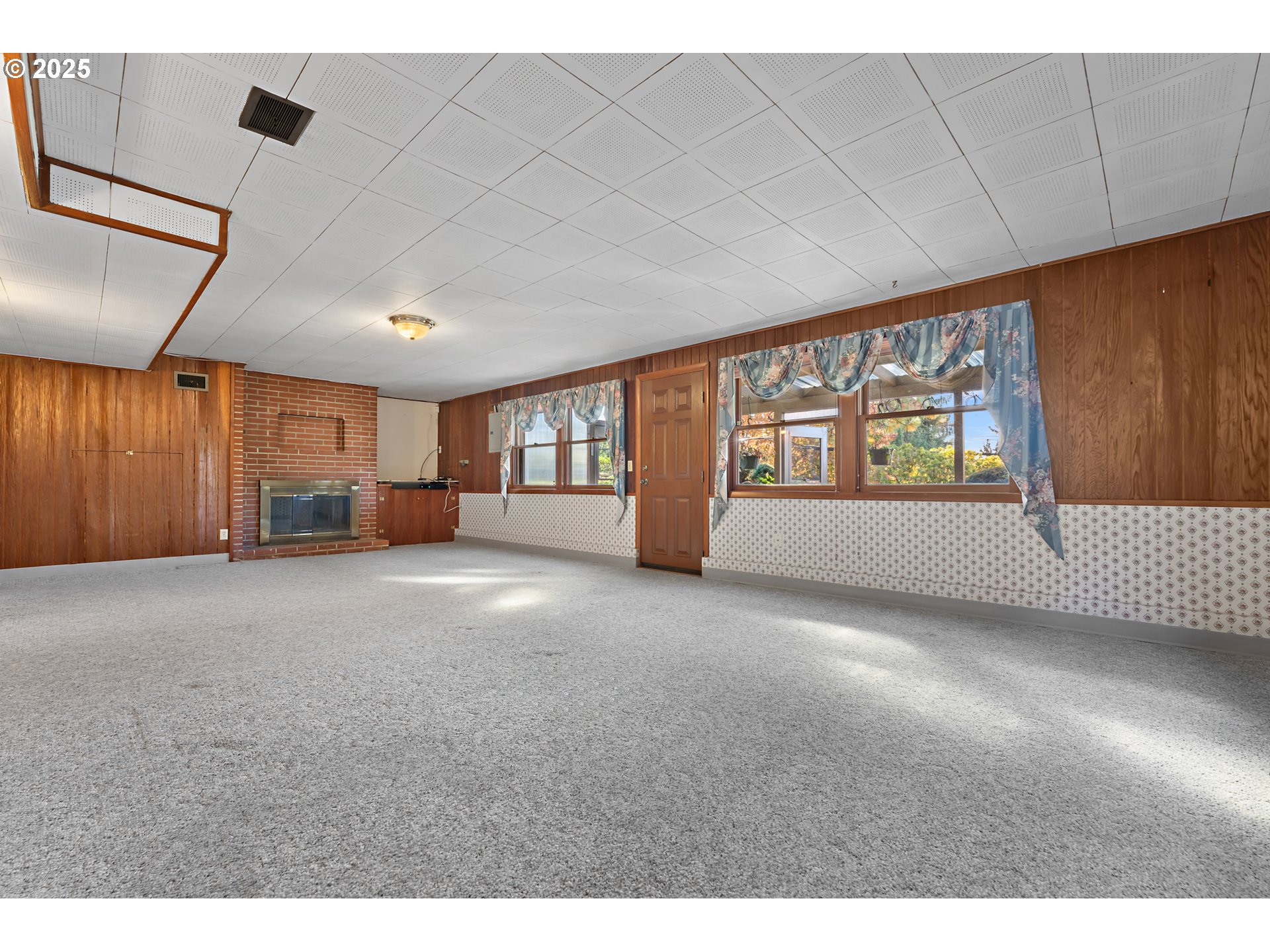4430 Southeast Flavel Street Portland, OR 97206 - Photo 27 of 43 a view of an empty room with a window and fireplace