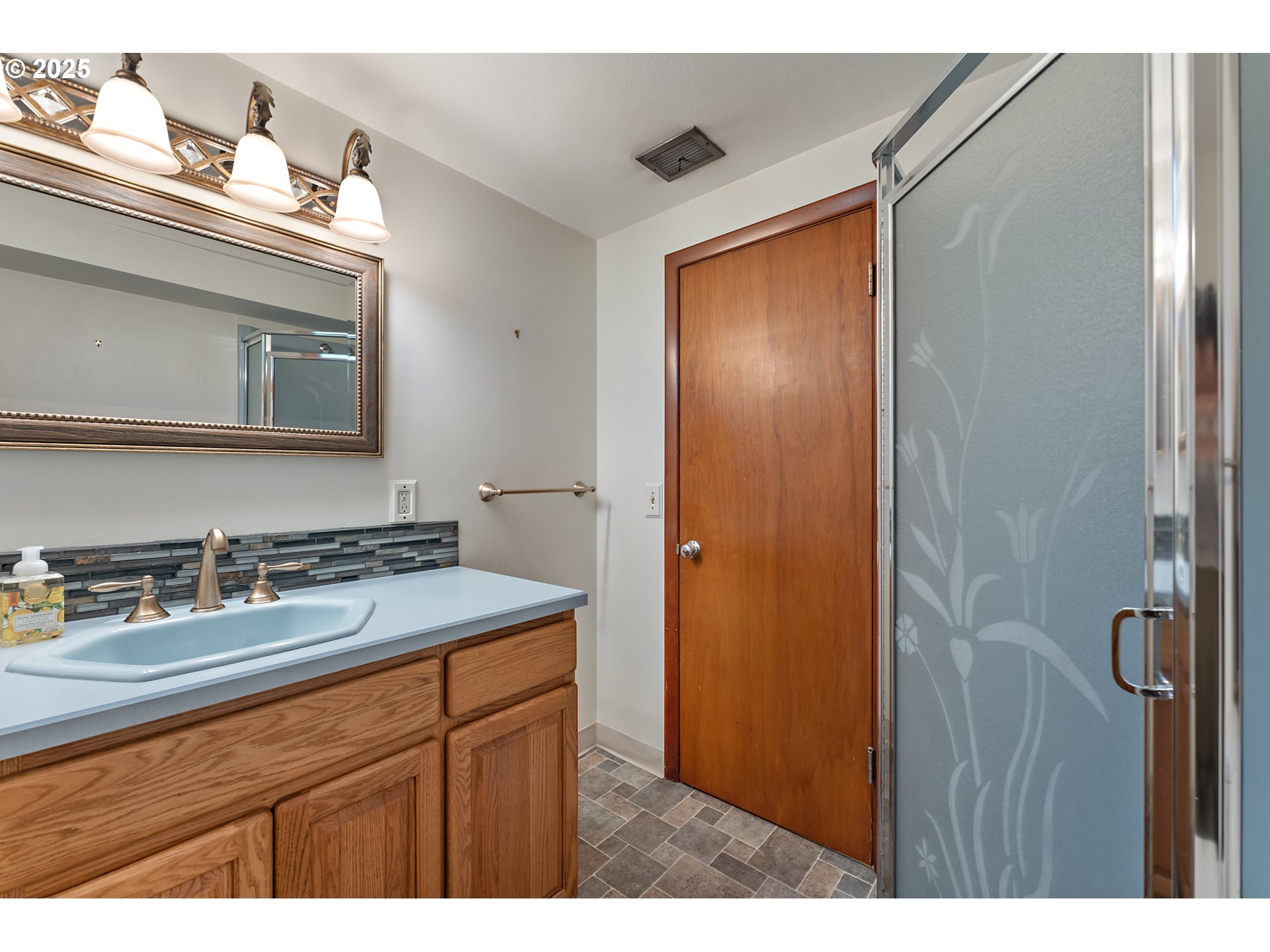 4430 Southeast Flavel Street Portland, OR 97206 - Photo 30 of 43 a bathroom with a sink a vanity and a mirror