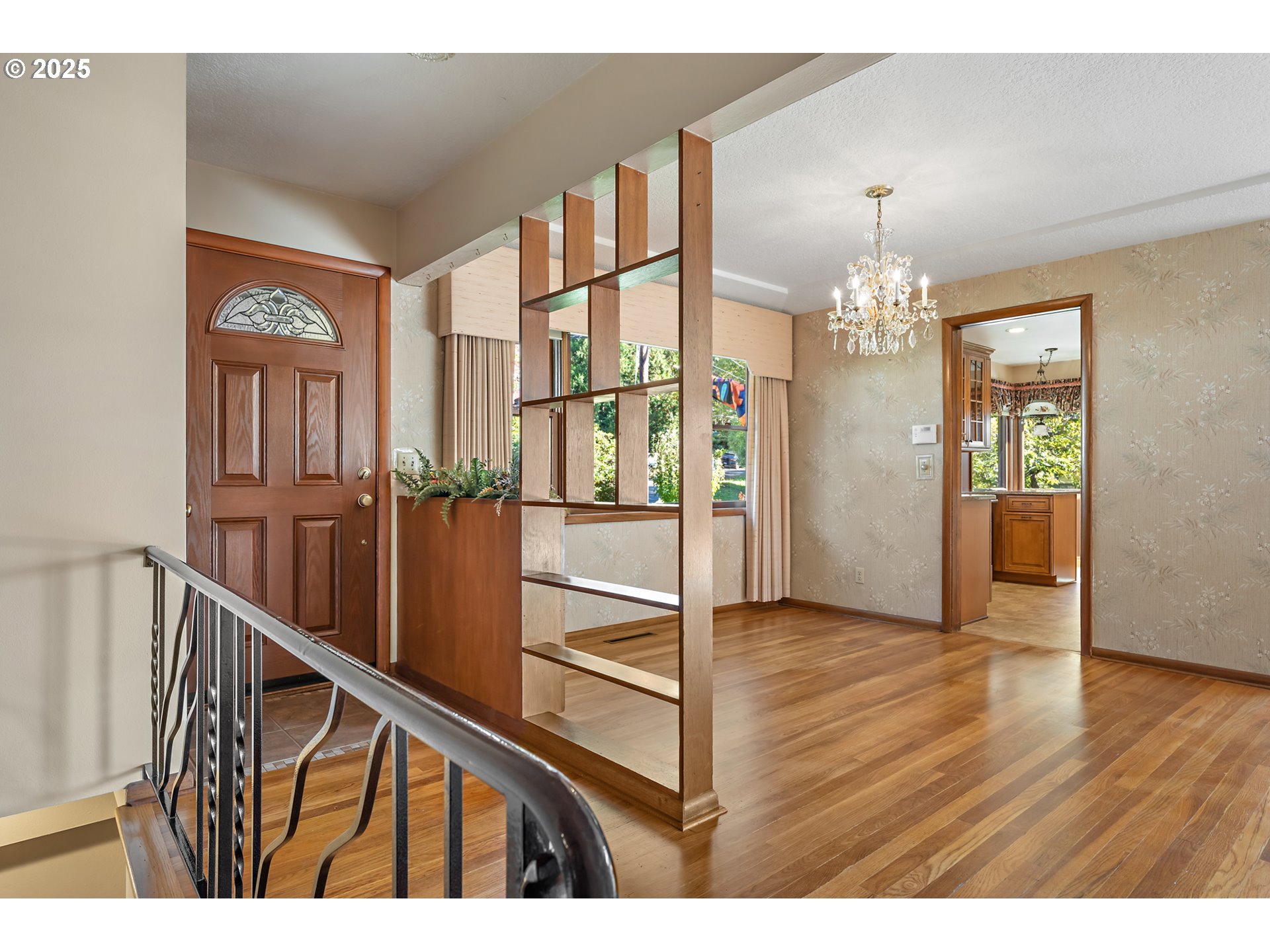 4430 Southeast Flavel Street Portland, OR 97206 - Photo 4 of 43 a view of a hallway with wooden floor and chandelier