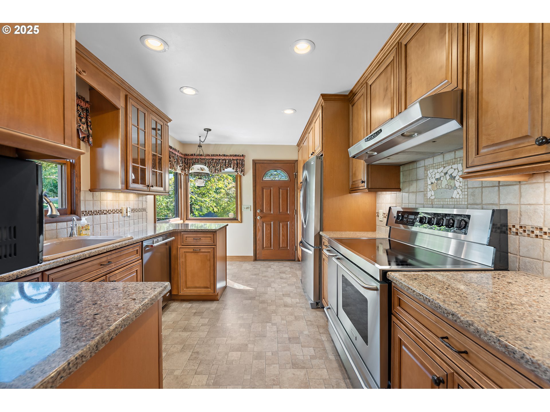 4430 Southeast Flavel Street Portland, OR 97206 - Photo 7 of 43 a kitchen with stainless steel appliances granite countertop a sink a stove and a wooden cabinets