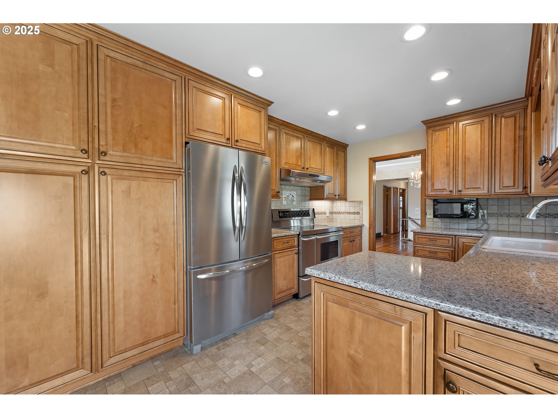 4430 Southeast Flavel Street Portland, OR 97206 - Photo 9 of 43 a kitchen with stainless steel appliances granite countertop a refrigerator a stove and a sink