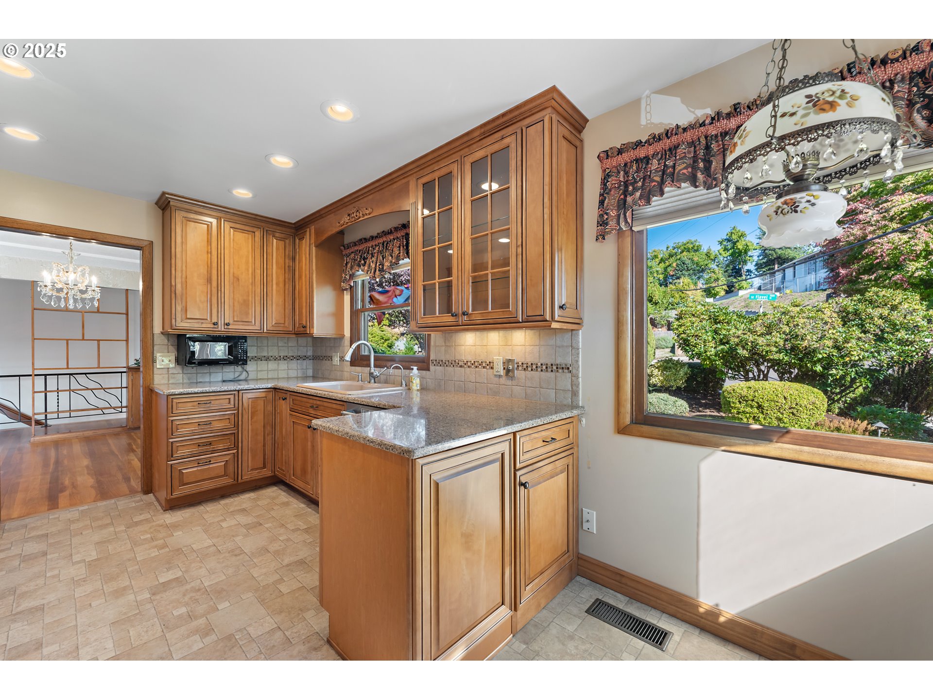 4430 Southeast Flavel Street Portland, OR 97206 - Photo 10 of 43 a kitchen with stainless steel appliances granite countertop a stove a sink and a microwave