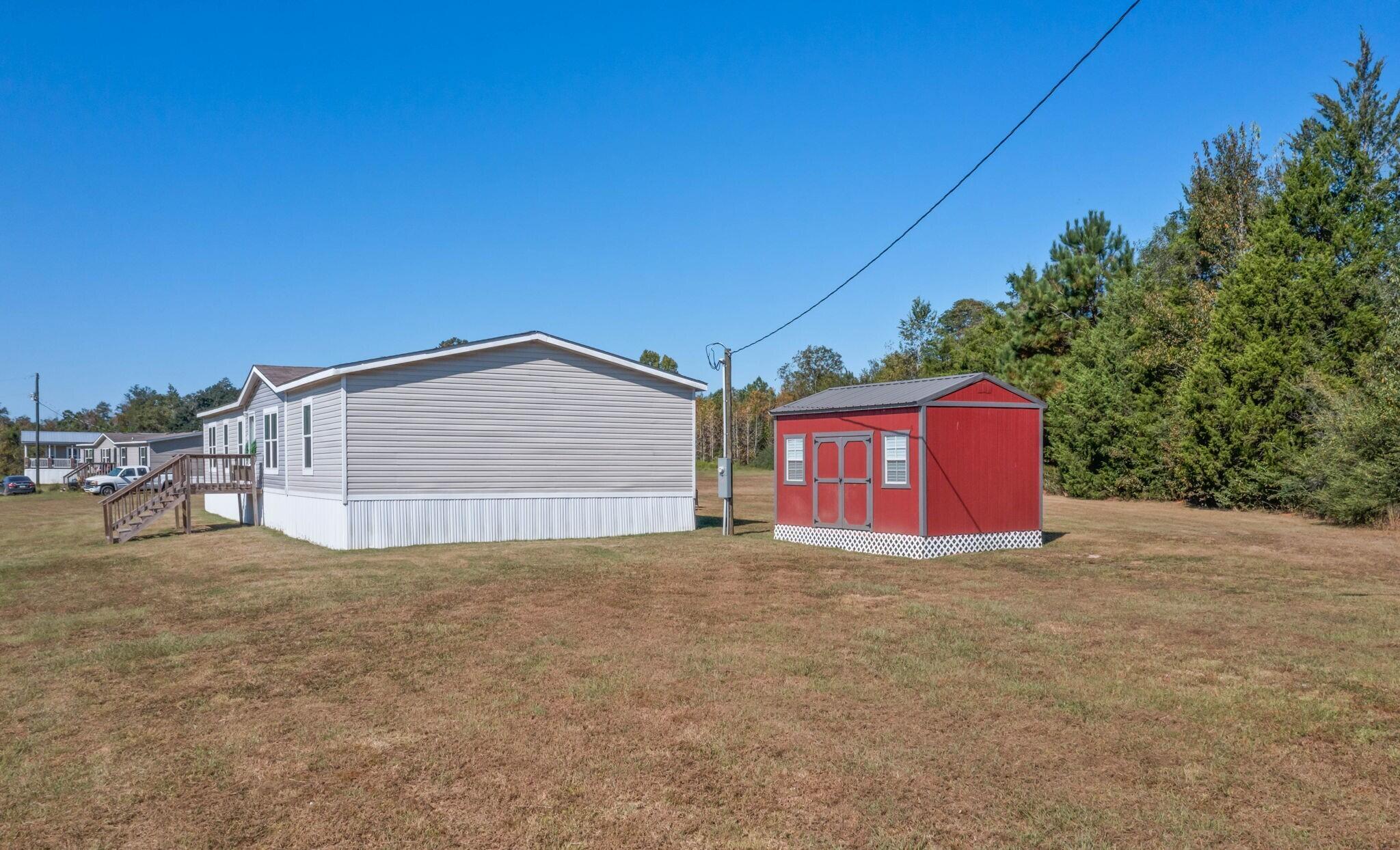 3139 Creek Road Bonifay, FL 32425 - Photo 20 of 41 a view of a house with a yard