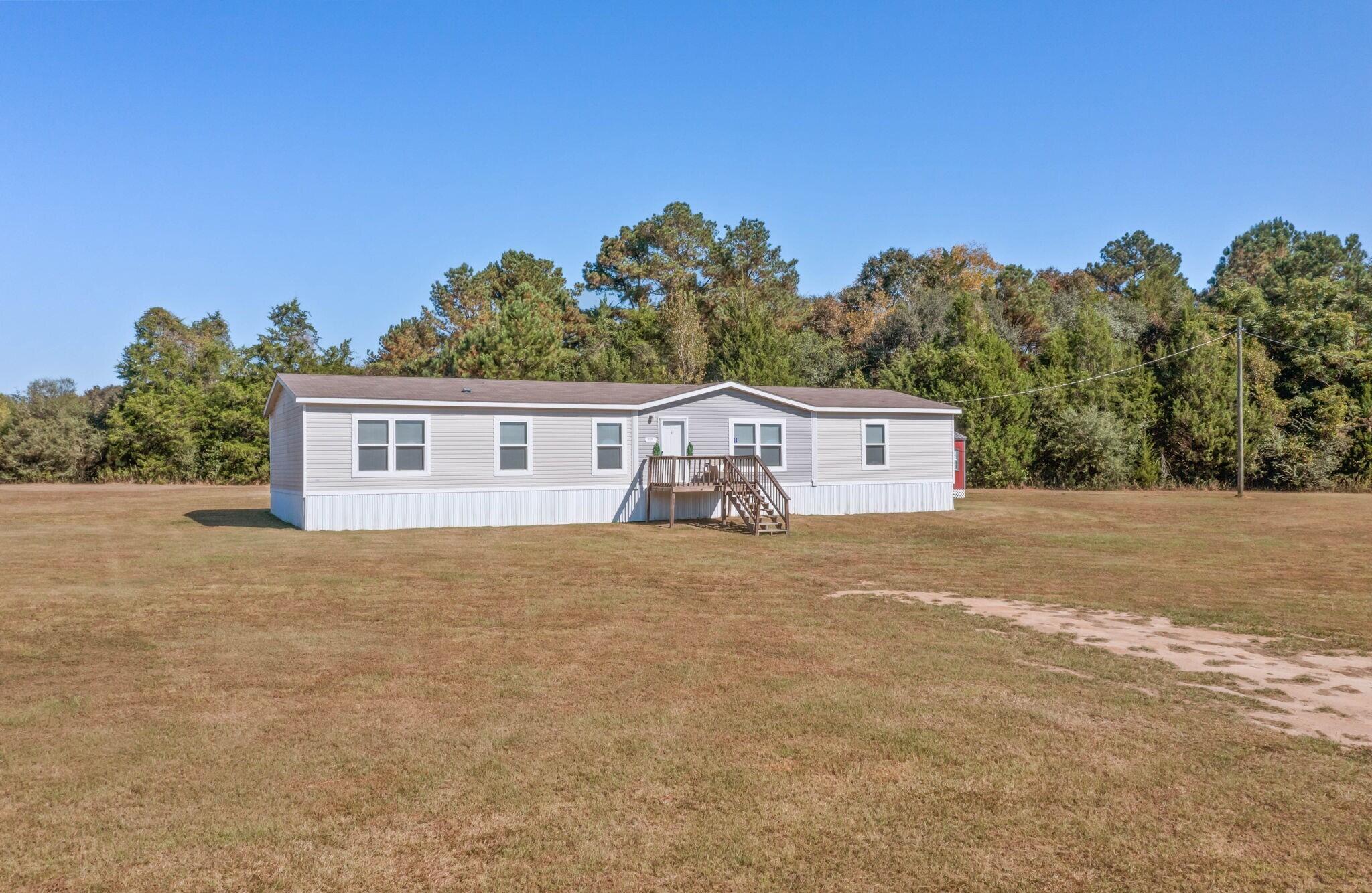 3139 Creek Road Bonifay, FL 32425 - Photo 22 of 41 a view of a house with a yard and large tree