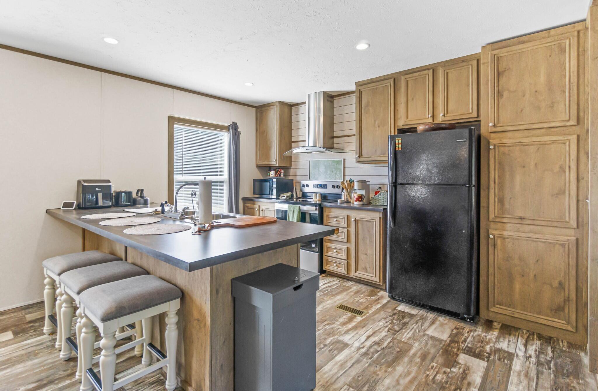3139 Creek Road Bonifay, FL 32425 - Photo 6 of 41 a kitchen with stainless steel appliances a refrigerator and a sink
