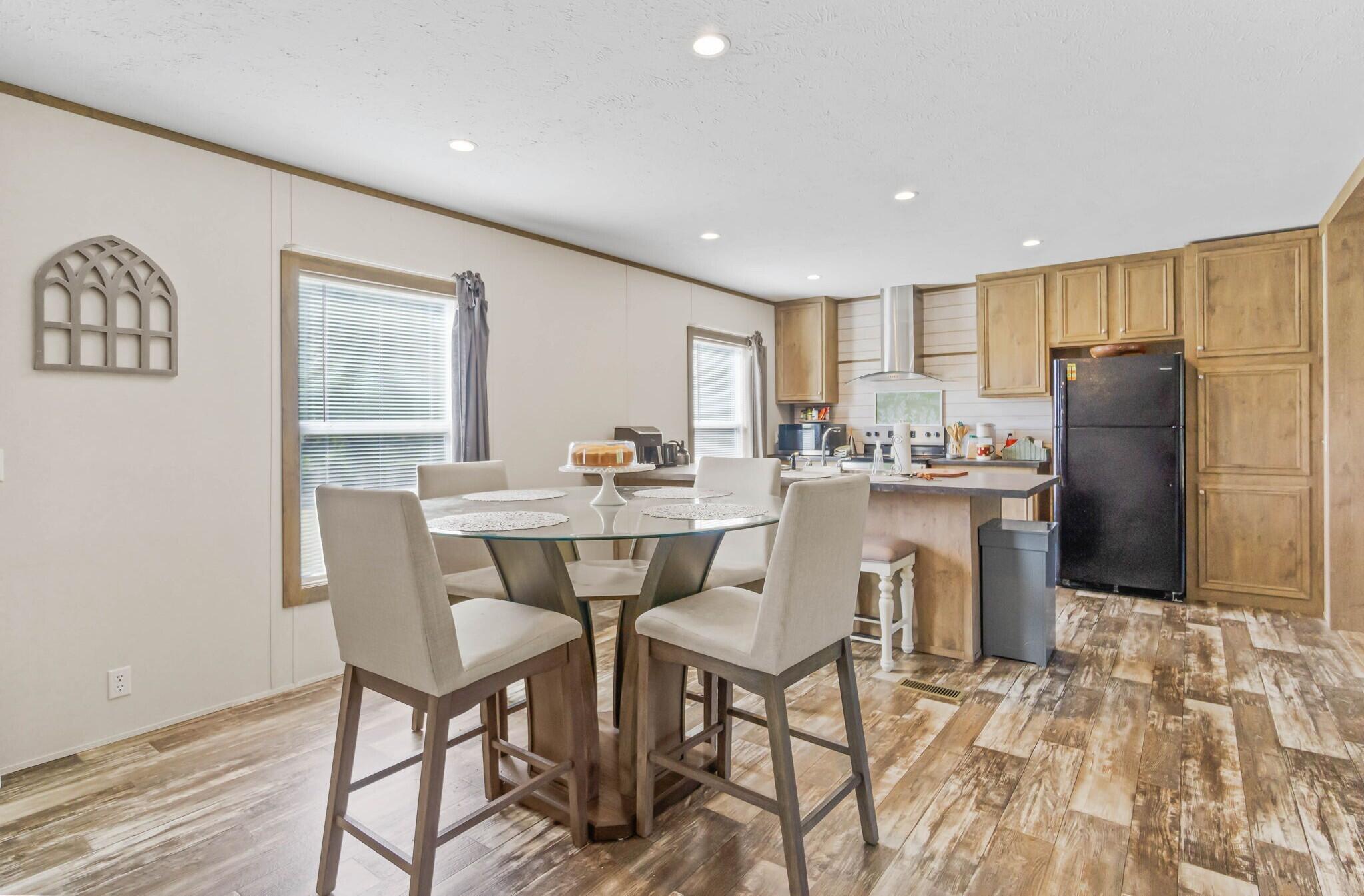 3139 Creek Road Bonifay, FL 32425 - Photo 7 of 41 a kitchen with stainless steel appliances a dining table chairs and refrigerator