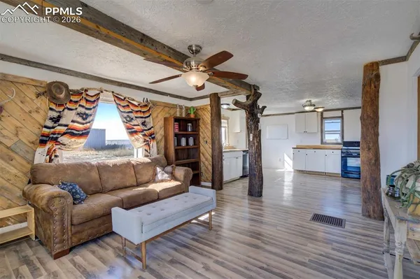 a living room with furniture and wooden floor