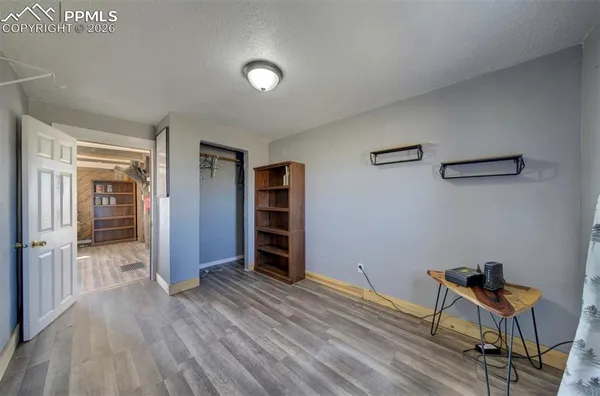 a view of hallway with a large window and wooden floor