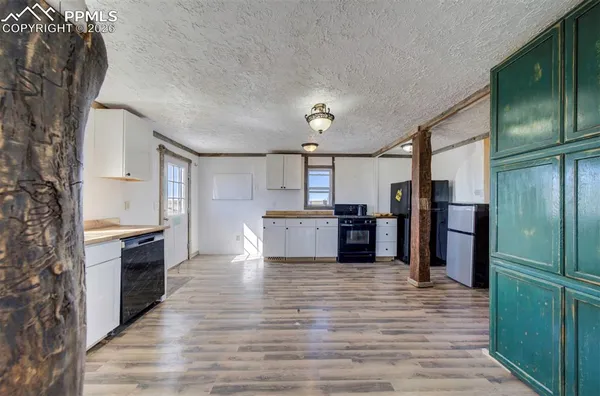a large kitchen with a refrigerator and a stove