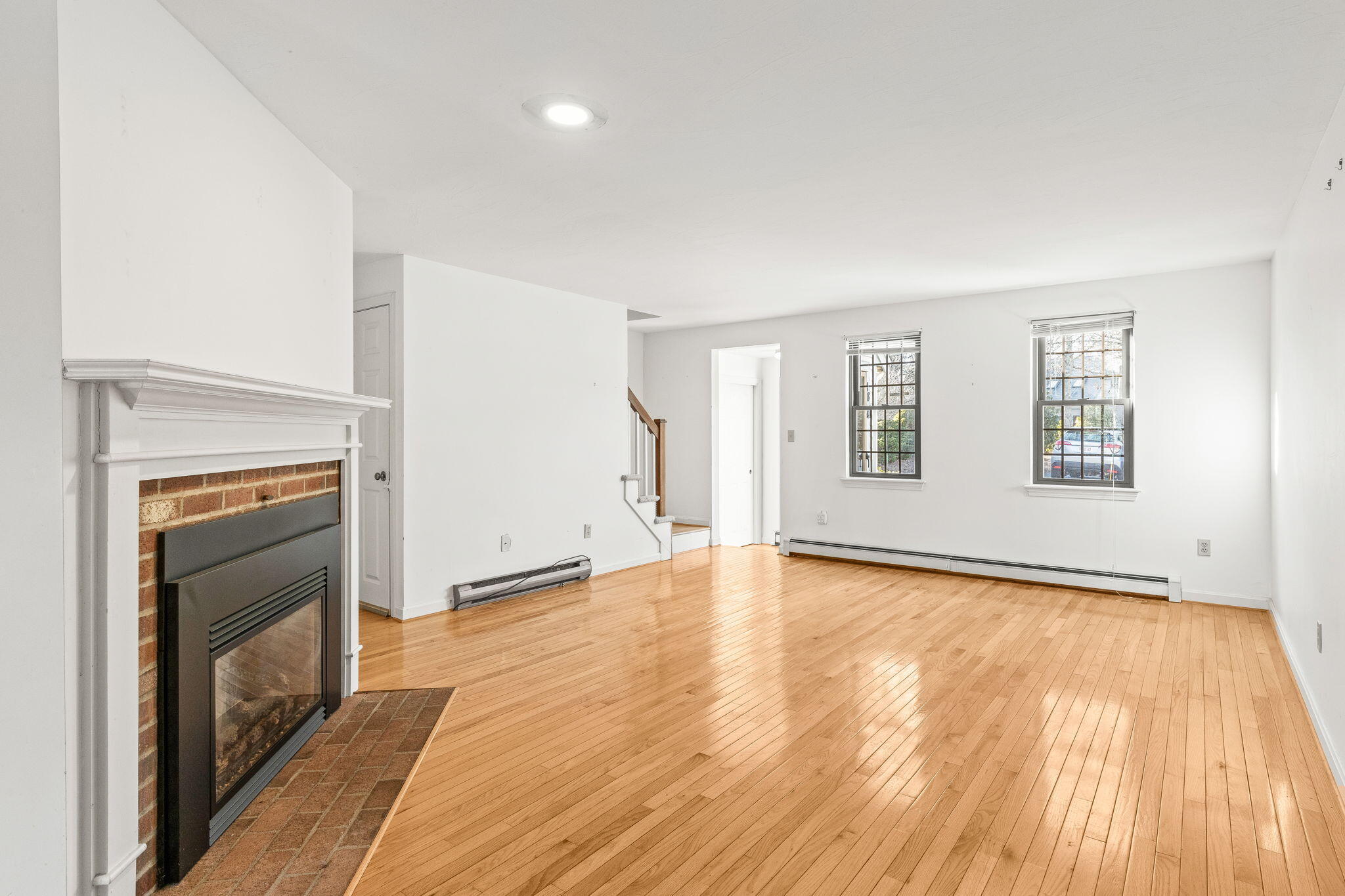 33 West Road, Unit 1B Orleans, MA 02653 - Photo 5 of 28 a view of an empty room with a fireplace and a window
