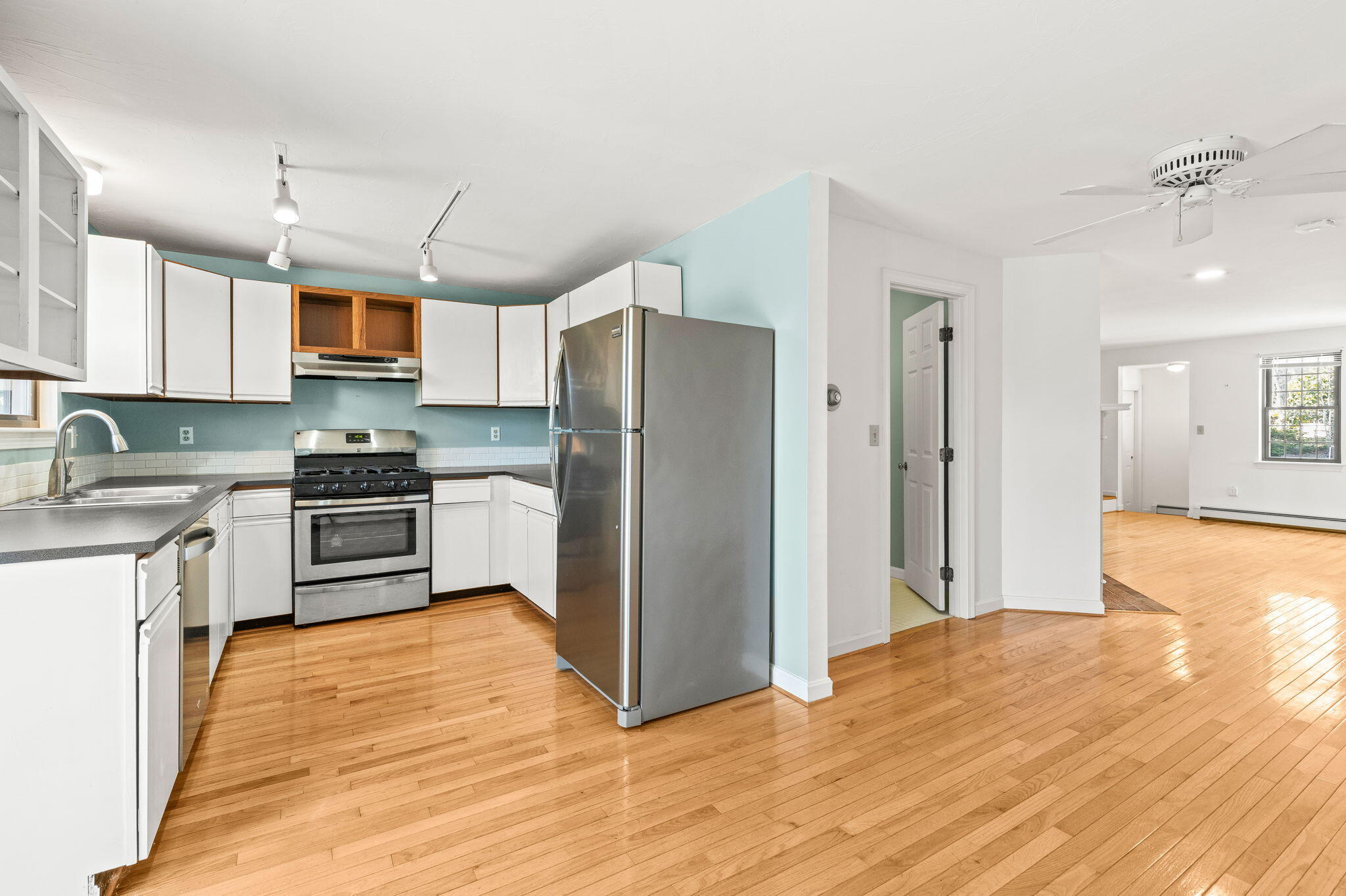 33 West Road, Unit 1B Orleans, MA 02653 - Photo 6 of 28 a kitchen with granite countertop a refrigerator and a stove top oven