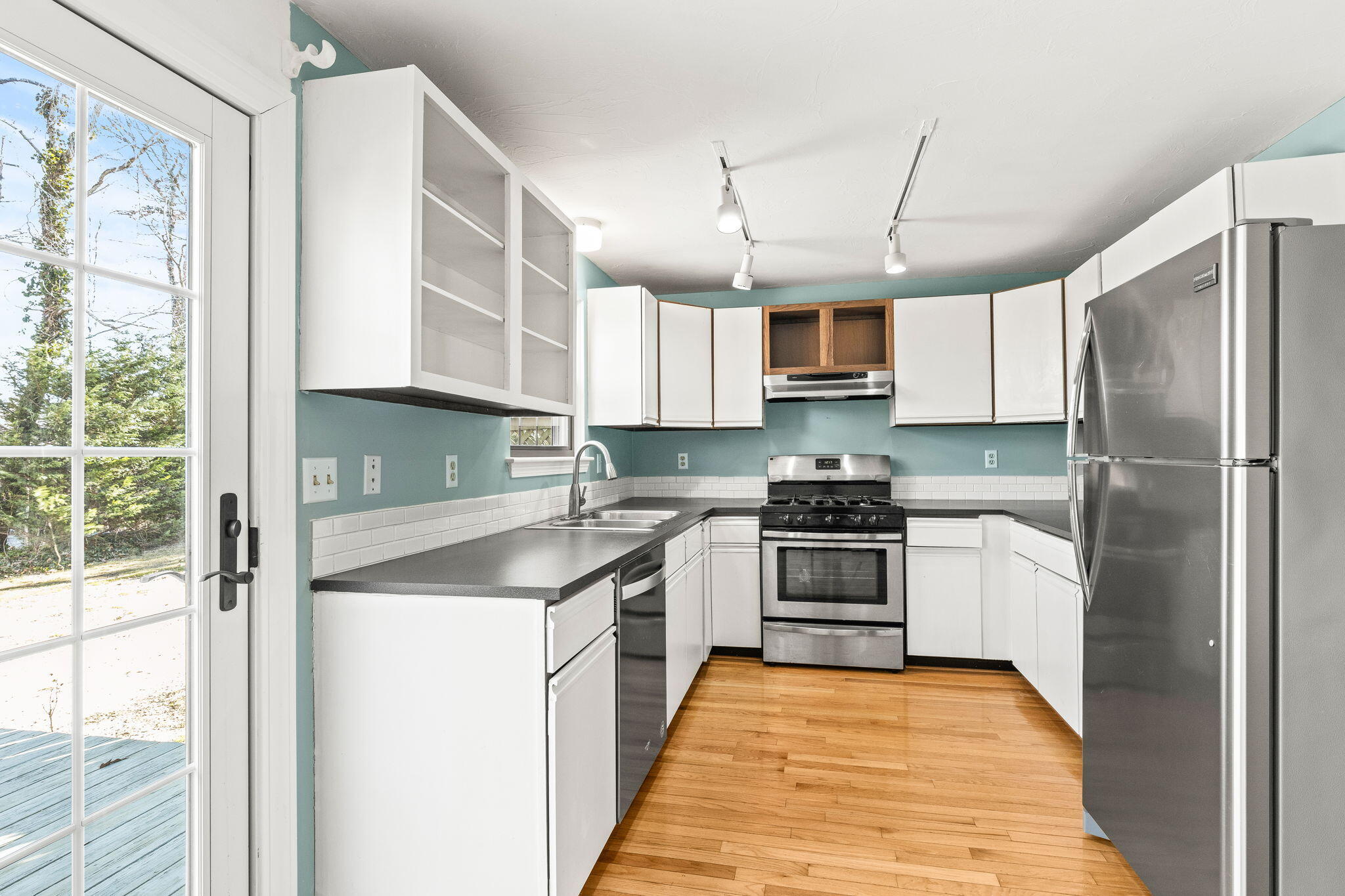 33 West Road, Unit 1B Orleans, MA 02653 - Photo 7 of 28 a kitchen with stainless steel appliances granite countertop a stove sink and refrigerator