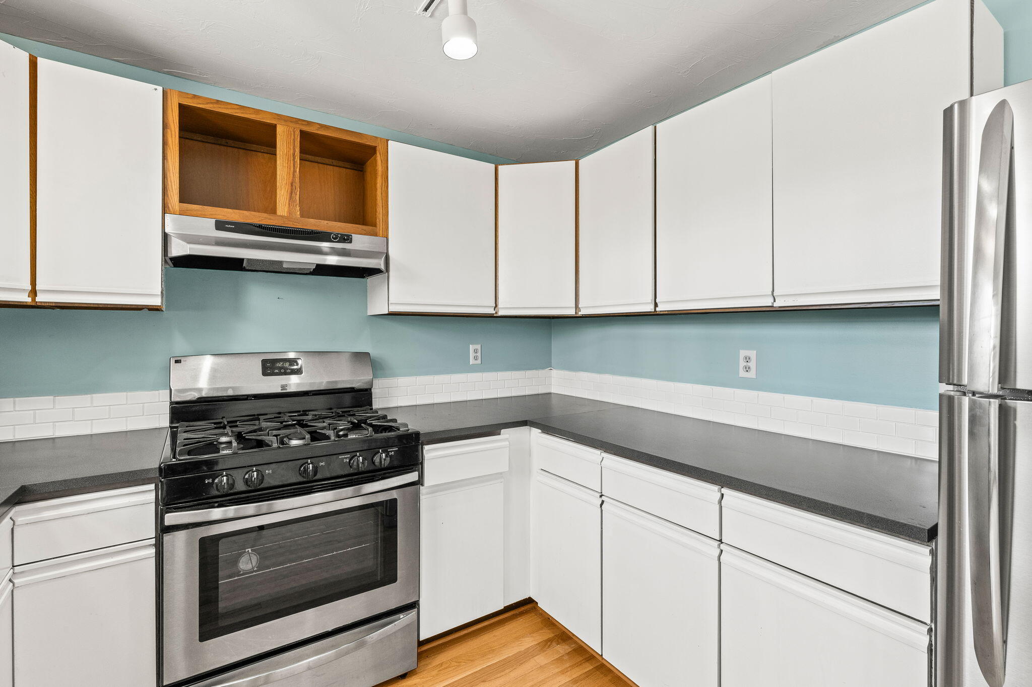 33 West Road, Unit 1B Orleans, MA 02653 - Photo 8 of 28 a kitchen with granite countertop white cabinets and stainless steel appliances
